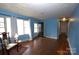 Living room with hardwood floors and access to hallway at 3217 Enfield Rd, Charlotte, NC 28205