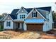 Two-story house with neutral siding, brown garage door, and light blue metal roof at 3634 46Th Ne Ave # 14, Hickory, NC 28601