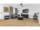 Living room with hardwood floors, fireplace, and comfy couch at 113 Dublin Ct, Statesville, NC 28677