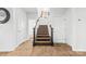 Staircase with brown carpeting and wooden handrail at 113 Dublin Ct, Statesville, NC 28677