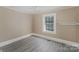 Simple bedroom with grey flooring and a window at 130 E Branch Ave, Shelby, NC 28152