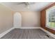 Bedroom with wood paneling, grey flooring, and a ceiling fan at 130 E Branch Ave, Shelby, NC 28152
