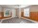 Bedroom with wood paneling, grey flooring, and two windows at 130 E Branch Ave, Shelby, NC 28152
