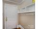 Laundry area with built-in shelving and a door at 130 E Branch Ave, Shelby, NC 28152