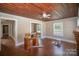 Living room with hardwood floors, brick fireplace, and wood ceiling at 130 E Branch Ave, Shelby, NC 28152