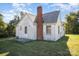 White sided home with a brick chimney and spacious yard at 130 E Branch Ave, Shelby, NC 28152