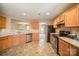 Bright kitchen featuring stainless steel appliances and wood cabinets at 105 Ranlo Ave, Gastonia, NC 28054