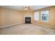 Living room with fireplace, ceiling fan and neutral walls at 105 Ranlo Ave, Gastonia, NC 28054