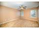 Well-lit bedroom with ceiling fan and neutral carpeting at 105 Ranlo Ave, Gastonia, NC 28054