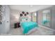 Bright bedroom with teal bedding, decorative wall accents, and a large window at 135 Saidin Ln, Troutman, NC 28166