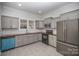 Modern kitchen with gray cabinets, stainless steel appliances, and wood countertops at 224 Wilson St, Albemarle, NC 28001