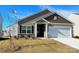 New construction home with two-tone siding, landscaping, and a two-car garage at 3216 Strong Box Ln, Gastonia, NC 28052