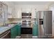 Kitchen with teal cabinets, stainless steel appliances, and granite countertops at 501 W Maryland Ave, Bessemer City, NC 28016