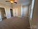 Bedroom with two windows, ceiling fan, and en-suite bathroom at 5773 Village Nw Dr, Concord, NC 28027