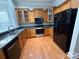 Kitchen with stainless steel appliances and wood cabinets at 5773 Village Nw Dr, Concord, NC 28027