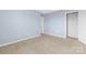 Light blue bedroom with neutral carpeting and closet at 107 Ashton Dr, Mooresville, NC 28115