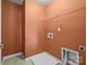 Laundry room with built-in shelving and light orange walls at 107 Ashton Dr, Mooresville, NC 28115