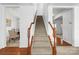 Elegant staircase with wood railings and neutral carpet at 107 Ashton Dr, Mooresville, NC 28115