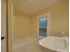 Clean bathroom featuring a tub, sink, and window at 126 E Division Ave, Salisbury, NC 28144