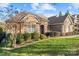 Brick home with stone accents and lush landscaping at 14700 Old Vermillion Dr, Huntersville, NC 28078