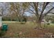 Spacious backyard with large trees and grassy area at 173 W Pine St, Norwood, NC 28128