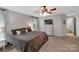 Main bedroom with king bed, dresser, and access to en-suite bathroom at 2559 Cypress Oak Ln, Gastonia, NC 28056