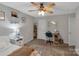 Bedroom with ceiling fan, desk, and ample closet space at 2559 Cypress Oak Ln, Gastonia, NC 28056