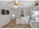 Bright bedroom with a comfortable bed, ceiling fan, and large window at 2559 Cypress Oak Ln, Gastonia, NC 28056