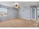 Spacious bedroom with neutral walls, ceiling fan, and carpet at 4117 Rosfield Dr, Charlotte, NC 28214