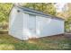 White detached garage with a single door, located in a grassy area at 571 Hillandale Ne St, Concord, NC 28025