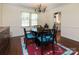 Bright dining room features hardwood floors, a round table with seating for four, and access to the kitchen at 7729 Bradenton Dr, Charlotte, NC 28210