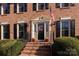 Brick home with a welcoming front porch and landscaping at 7729 Bradenton Dr, Charlotte, NC 28210