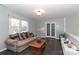 A spacious living room filled with natural light and french doors at 8443 Middleton Cir, Harrisburg, NC 28075