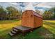 Well-maintained storage shed with a wooden deck and steps at 119 Isaac Rd, Statesville, NC 28625