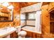 Bathroom with jetted tub, wood paneling, and a pedestal sink at 119 Isaac Rd, Statesville, NC 28625