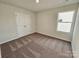 Bright bedroom with carpet, window, and double doors at 127 Lightning Dr, Shelby, NC 28152