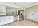 Modern kitchen with white cabinets, granite countertops, and stainless steel appliances at 1514 Waybridge Ln, Charlotte, NC 28210