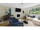 Virtually staged living room featuring a fireplace and large window at 1514 Waybridge Ln, Charlotte, NC 28210