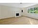 Living room with fireplace and light hardwood floors at 1514 Waybridge Ln, Charlotte, NC 28210