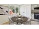 Virtually staged dining area featuring a round wooden table and four chairs at 1514 Waybridge Ln, Charlotte, NC 28210