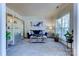 Living room with a blue sofa, glass coffee table, and built-in shelving at 3848 Burnage Hall Rd, Harrisburg, NC 28075