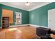 Spare bedroom with hardwood floors, a wood burning stove, and green walls at 5198 Old Hickory Rd, Lancaster, SC 29720