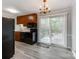 Kitchen with wood cabinets, black appliances, and a breakfast bar at 5903 Quail Hollow Rd # D, Charlotte, NC 28210