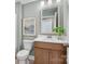 Clean bathroom with wood vanity, white toilet, and a framed picture at 1037 Kinship Dr # 75, Lancaster, SC 29720