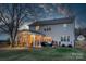 Two-story house back view with screened porch and backyard at 1124 Woodwinds Dr, Waxhaw, NC 28173