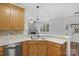 Modern kitchen with island, light wood cabinets and stainless steel appliances at 1124 Woodwinds Dr, Waxhaw, NC 28173