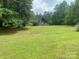 A-frame home exterior with spacious lawn and surrounding trees at 2484 Shelton Ave, Statesville, NC 28677