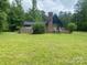 Exterior of home showcasing a large deck and surrounding landscape at 2484 Shelton Ave, Statesville, NC 28677