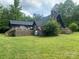 A-frame home with large deck and surrounding trees at 2484 Shelton Ave, Statesville, NC 28677