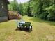 Green backyard with patio furniture and deck access at 2484 Shelton Ave, Statesville, NC 28677
